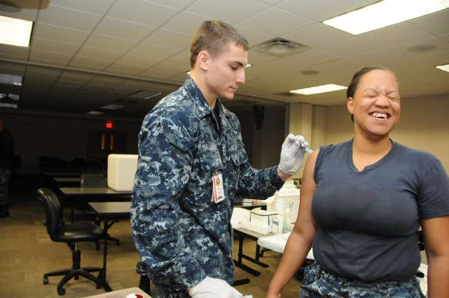 Hospital Corpsman 3rd Class Robert Salamone gives a flu shot to a Naval Station Mayport Sailor during a Shot Ex with the HMs from Naval Branch Health Clinic Mayport. NBHC Mayport has received its supply of flu vaccines and is making them available