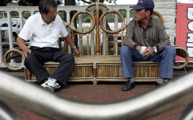 Former North Koreans talk in front of the community centre of Abaimaul or''Town of Grandpas' in North Korean dialect a village of low-lying houses by the port of Sokcho east of Seoul in this Sep 17 2007 file