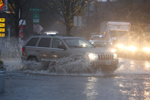 Pouring rain and clogged storm drains caused flooding in the streets near the corner of SE 12th and Hawthorne in Portland Ore. Monday Dec. 7 2015. The National Weather Service on Monday issued a flood watch for much of northwest Oregon and southwest