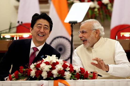 Japanese Prime Minister Shinzo Abe and Indian Prime Minister Narendra Modi laughed after signing an agreement at Hyderabad House in New Delhi on Saturday