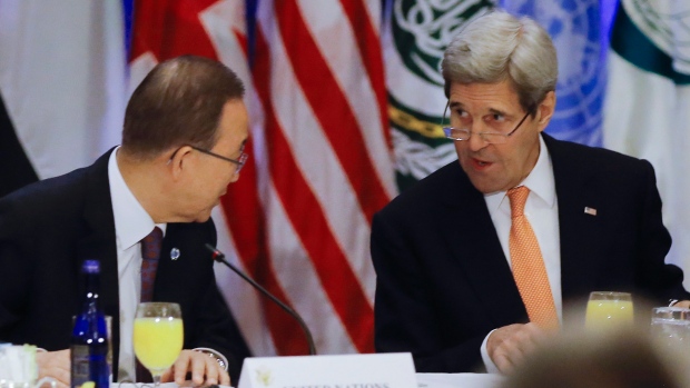 United Nations Secretary General Ban Ki-moon and U.S. Secretary of State John Kerry speak before a meeting of the International Syria Support Group at a hotel in New York Friday. Later Friday the UN Security Council adopted a resolution to reach a neg