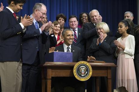 President Barack Obama flanked by Senate Health Education Labor and Pensions Committee Chairman Sen. Lamar Alexander R-Tenn. left and the committee's ranking member Sen. Patty Murray D-Wash. smiles after signing the'Every Student Succeeds Ac