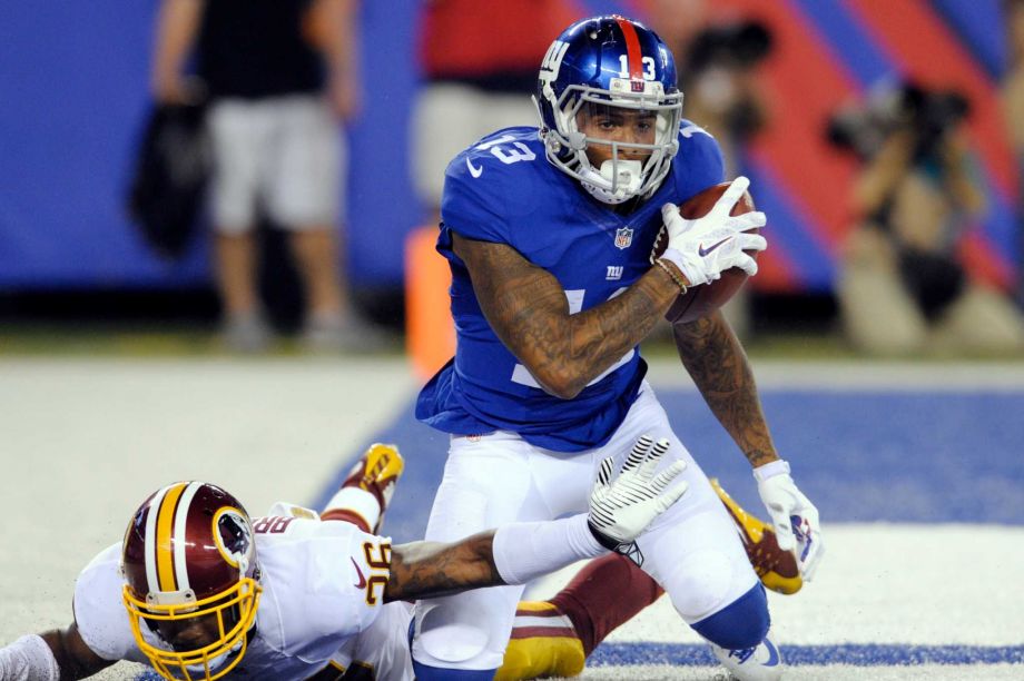 New York Giants wide receiver Odell Beckham Jr. celebrates as Washington Redskins Bashaud Breeland reaches for him after Beckham scored a touchdown during the second half an NFL football game in East R