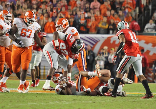 Then-sophomore defensive lineman Adolphus Washington gets up after tackling an opposing player during the 2014 Discover Orange Bowl Jan. 3 at Sun Life Stadium. OSU lost 40-35. Credit Shelby Lum