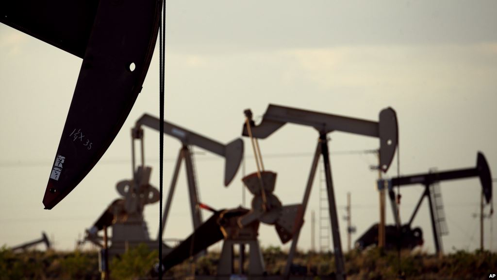 Pumpjacks bob in a field near Lovington N.M. World oil prices which have been declining fell further Monday when Iran restated its plan to increase crude exports