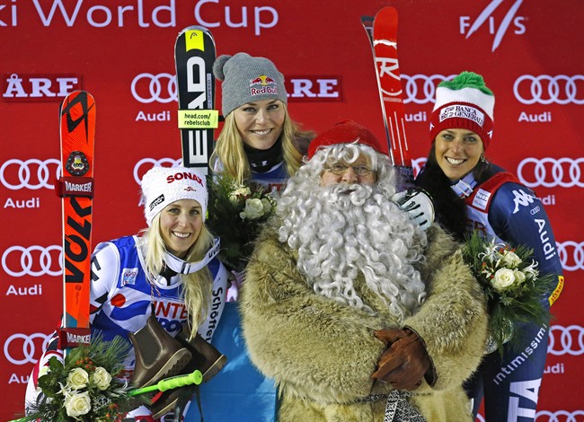 From left second placed Austria's Eva Maria Brem first placed Lindsey Vonn of the United States and third placed Italy's Federica Brignone celebrate with a man dressed as Santa Claus on the podium of a women's World Cup giant slalom in Are Sweden Sat