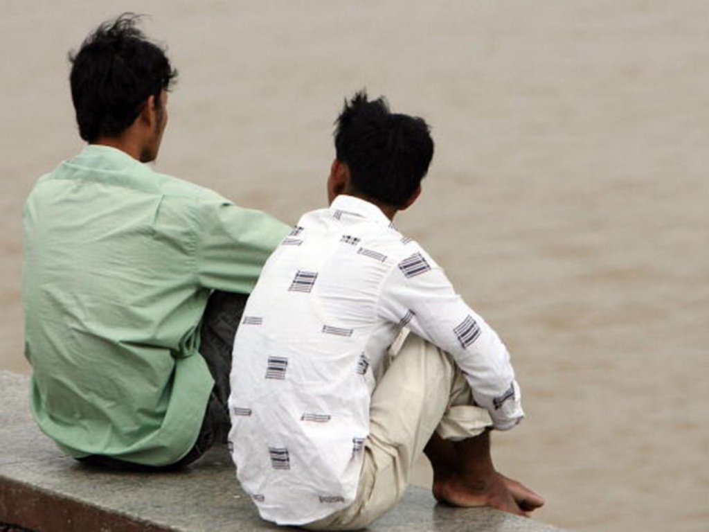 Young men gather on the busy riverside in Phnom Penh. The area is a favourite haunt of men seeking sex with other men a growing practice here that health officials say is undermining HIV  Aids prevention efforts