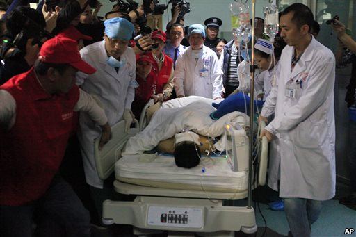 Medical staff move landslide survivor Tian Zeming following surgery in a hospital in Shenzhen in southern China's Guangdong province on Dec. 23 2015. Rescuers pulled Tian from the rubble of a massive landslide in Shenzhen early on Wednesday. (Chinato