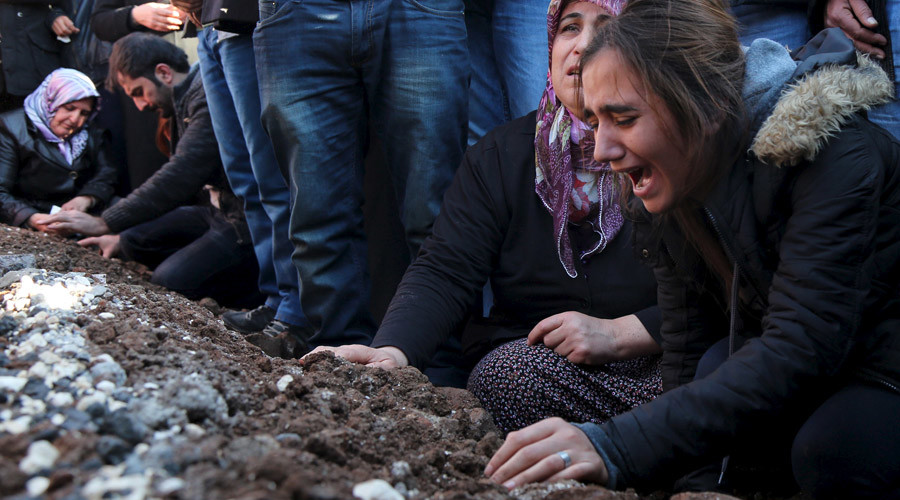 Relatives of Siyar Salman mourn over his grave during a funeral ceremony in the Kurdish dominated southeastern city of Diyarbakir Turkey