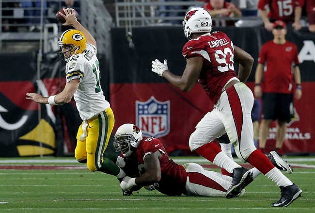 Green Bay Packers quarterback Aaron Rodgers is tackled by Arizona Cardinals defensive end Frostee Rucker during the second half of an NFL football game Sunday Dec. 27 2015 in Glendale Ariz