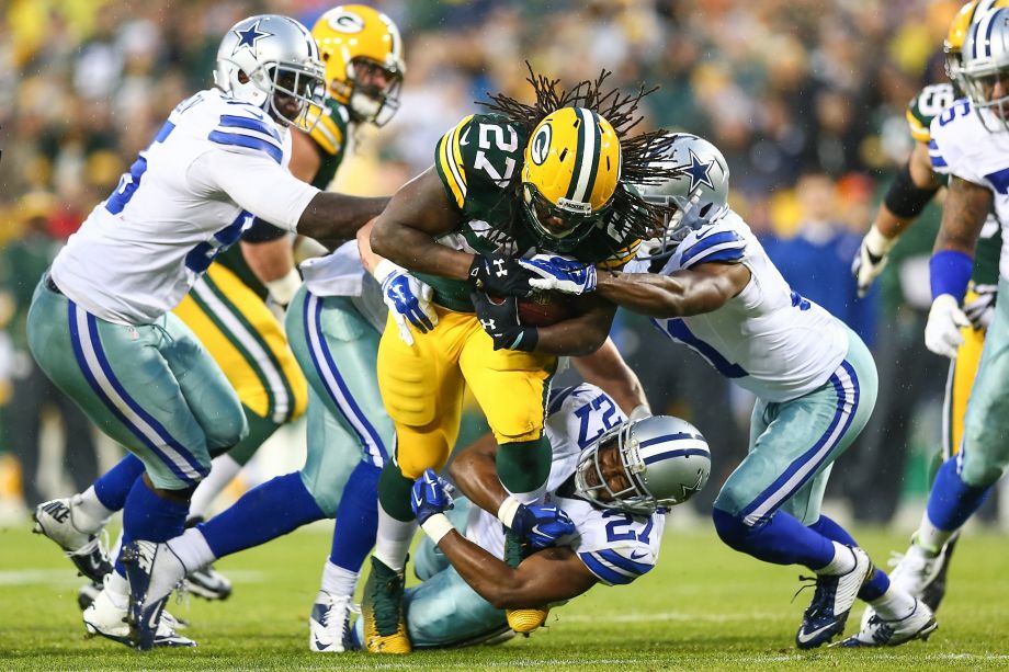 Packers running back Eddie Lacy who rushed for 124 yards is tackled by J.J. Wilcox in the first half