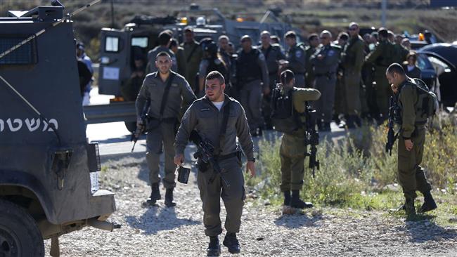 Israeli forces gather at the scene where a Palestinian man was shot dead at the Tapuah junction south of Nablus in the Israeli-occupied West Bank