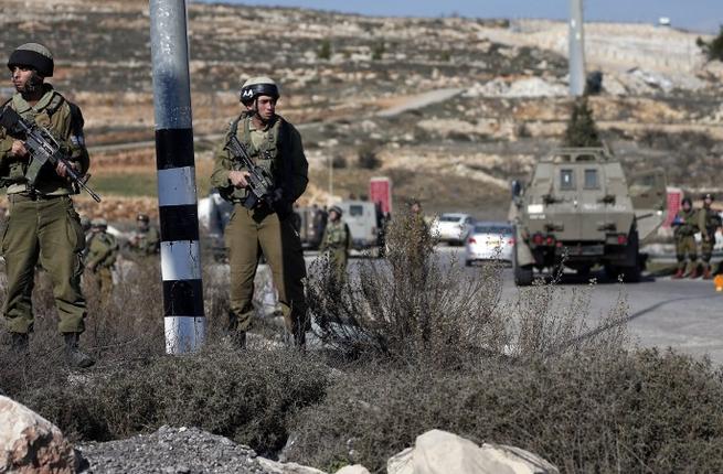 Israeli security forces secure the area after a Palestinian attempted to ram his vehicle into security forces at a military checkpoint