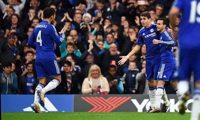 Pedro celebrates with Oscar and Cesc Fabregas after scoring the second goal for Chelsea