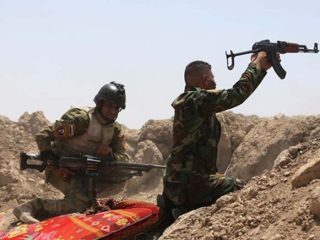 Iraqi soldiers fire towards Islamic State group positions in the Garma district of Anbar province west of the Iraqi capital Baghdad