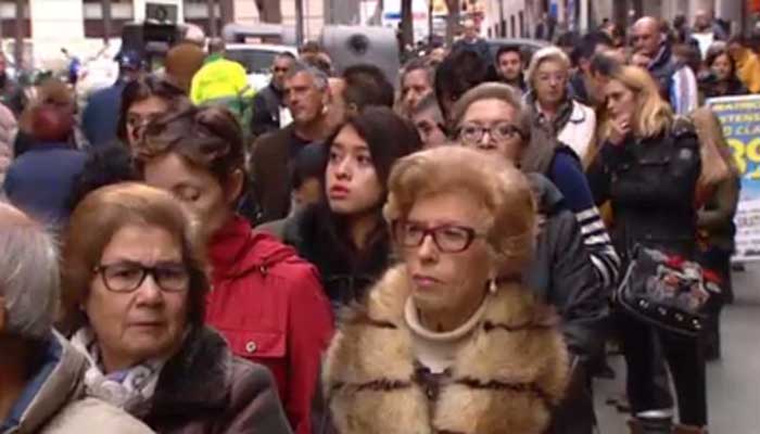 People in Madrid line up to buy lottery tickets