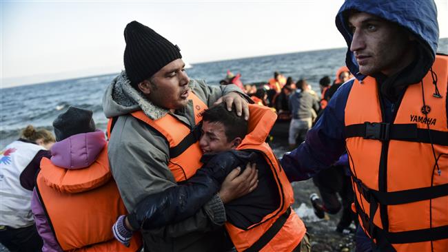 People react after arriving on the Greek island of Lesbos along with other refugees