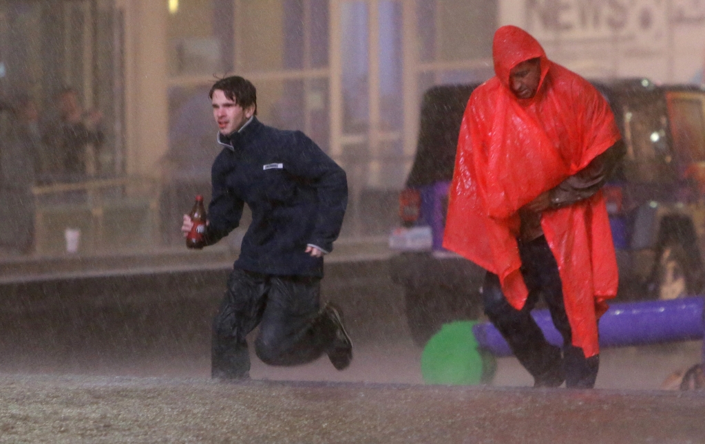 People run as weather sirens sound as a severe storm passes over downtown Dallas Saturday