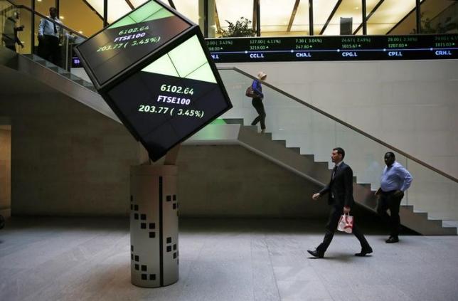 People walk through the lobby of the London Stock Exchange in London Britain