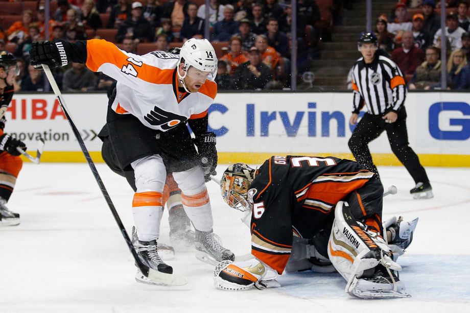 Anaheim Ducks goalie John Gibson right stops a shot by Philadelphia Flyers Sean Couturier during the first period of an NHL hockey game Sunday Dec. 27 2015 in Anaheim Calif