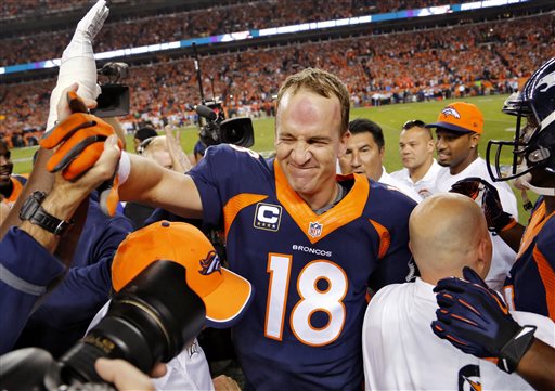 Denver Broncos quarterback Peyton Manning celebrates his 509th career touchdown pass with teammates during the first half of an NFL football game against the San Francisco 49ers Sunday Oct. 19 2014 in Denver