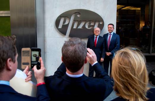 Ian Read chairman and chief executive officer of Pfizer left and Brent Saunders the president and chief executive officer of Allergan stand for