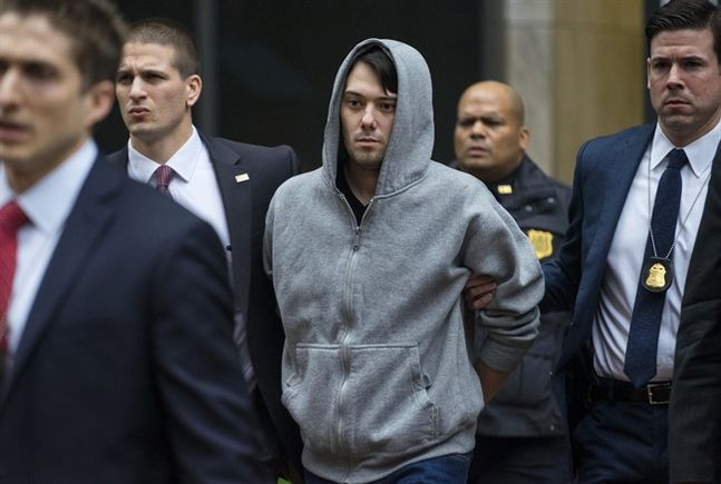 Martin Shkreli the former hedge fund manager under fire for buying a pharmaceutical company and ratcheting up the price of a life-saving drug is escorted by law enforcement agents in New York after being taken