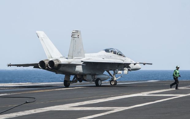 A United States F  A-18F Super Hornet lands on aircraft carrier USS George H.W. Bush after carrying out strikes on IS targets