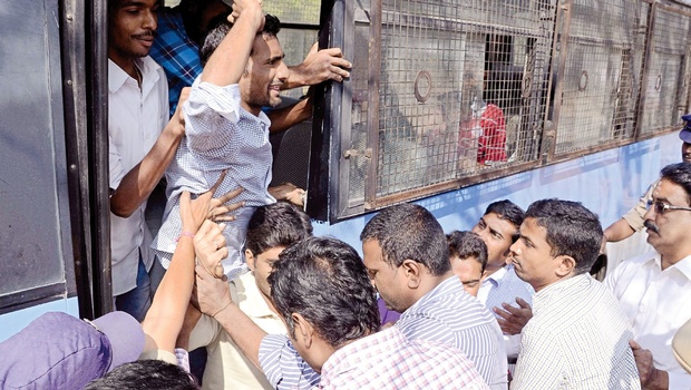 Police arresting students as they took out a rally in support of Beef Festival at Osmania University Campus in Hyderabad on Monday | Express