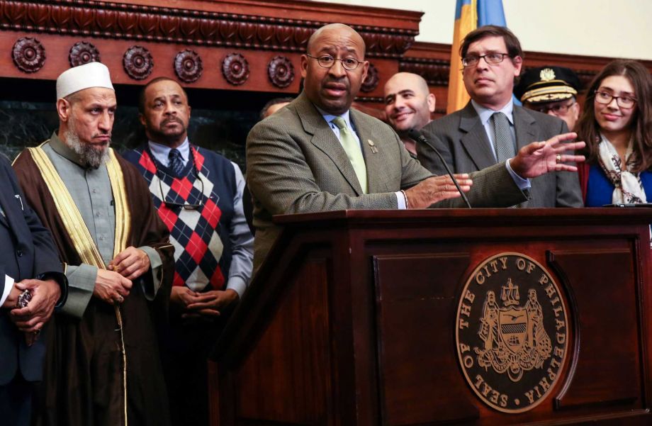 Philadelphia Mayor Michael Nutter center front joins with interfaith leaders to speak to the media in Philadelphia after a severed pig's head was found outside the Al Aqsa Islamic Society. Advocacy groups believ