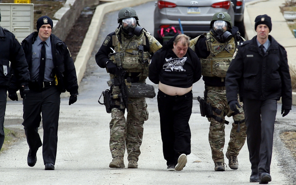 Police escort a suspected fugitive wanted in connection with a bomb threat after a tense eight hour standoff in Hempfield Pa. The recent Planned Parenthood shooting in Co. resulted in police taking the conservative white male suspect alive causing many