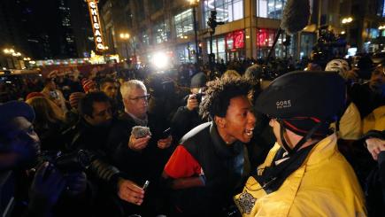 Lamon Reccord yells at a Chicago police officer during a rally over the death of Laquan Mc Donald