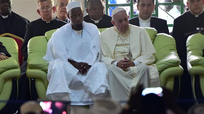 Pope Francis looks on alongside Imam Nehedid Tidjani, during a visit to the Central Mosque in Bangui