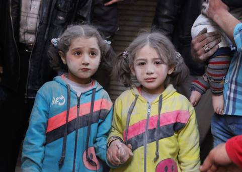 Girls who survived what activists said was a ground-to-ground missile attack by forces of Syria’s President Bashar al-Assad hold hands at Aleppo’s Bab al Hadeed district yesterday