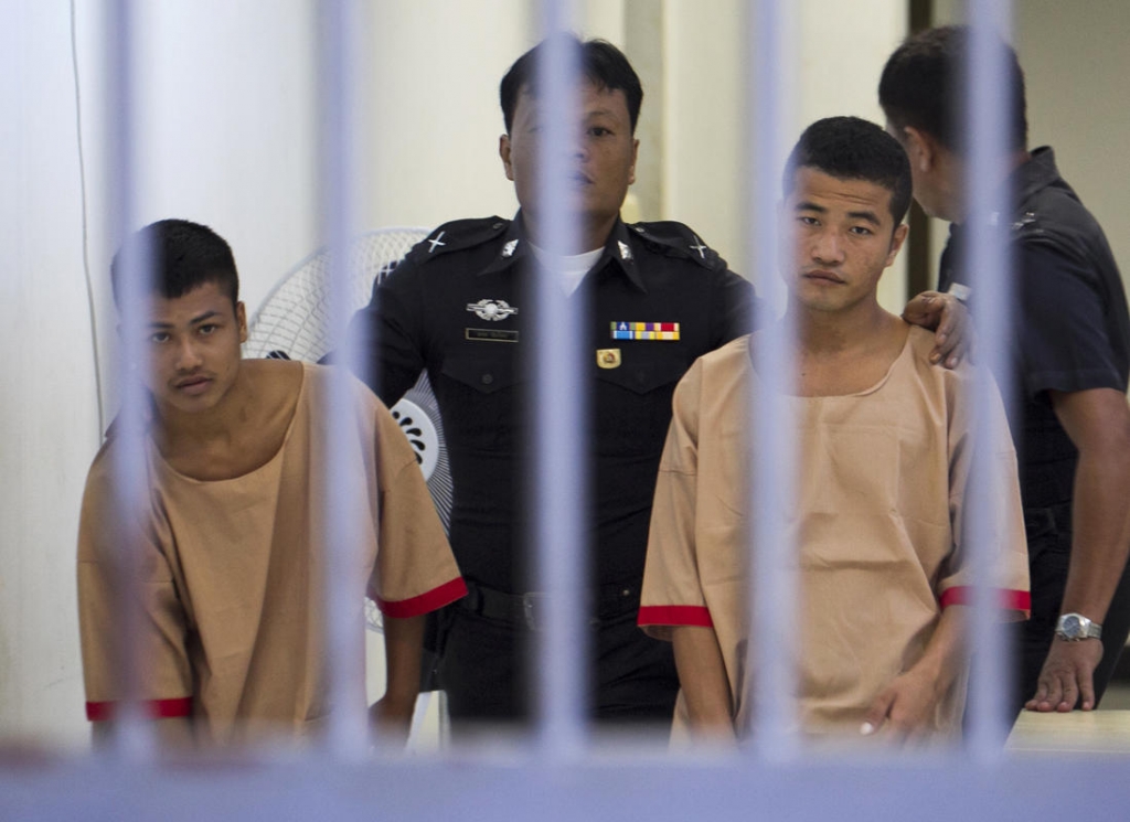 Myanmar migrants Win Zaw Htun right and Zaw Lin left both 22 are escorted by officials after their guilty verdict at court in Koh Samui Thailand Thursday Dec. 24 2015. Credit The Boston Herald  AP