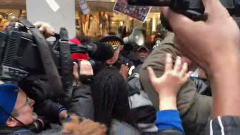 Protesters and police get jostled during Thursday's protest on the Magnificent Mile