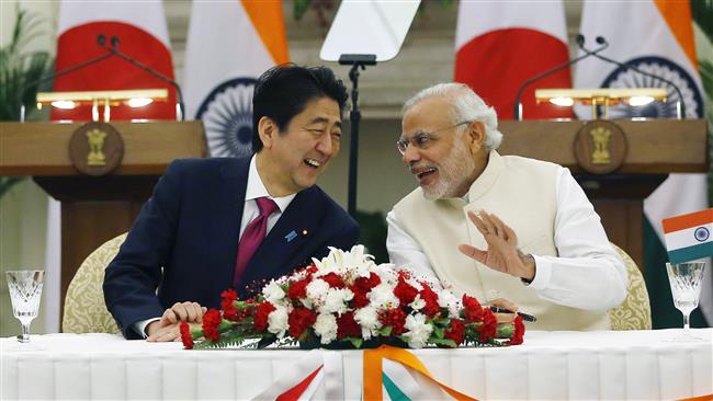 Japan's Prime Minister Shinzo Abe and his Indian counterpart Narendra Modi shares a moment during a signing of agreement at Hyderabad House in New Delhi India