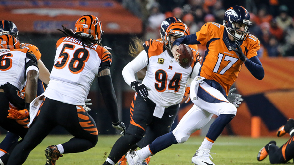 Quarterback Brock Osweiler scrambles as defensive tackle Domata Peko of the Cincinnati Bengals chases him down