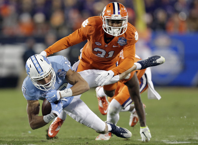 Clemson's Ryan Carter moves in to tackle North Carolina's Mack Hollins during the half of the Atlantic Coast Conference championship NCAA college football game in Charlotte N.C. Saturday Dec. 5 2015