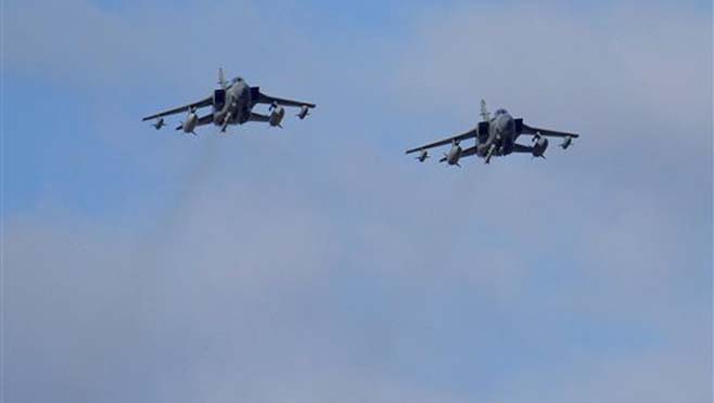 Two British Tornados warplanes fly over the RAF Akrotiri a British air base near costal city of Limassol Cyprus Thursday Dec. 3 2015 as they arrive from an airstrike against Islamic State group targets in Syria. British warplanes carried out airstri