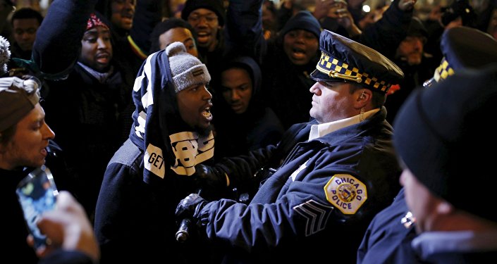 Demonstrators confront police officers during a protest in reaction to the fatal shooting of Laquan Mc Donald in Chicago Illinois