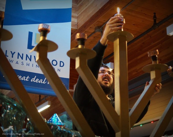 Rabbi Berel Paltiel lights the Menorah