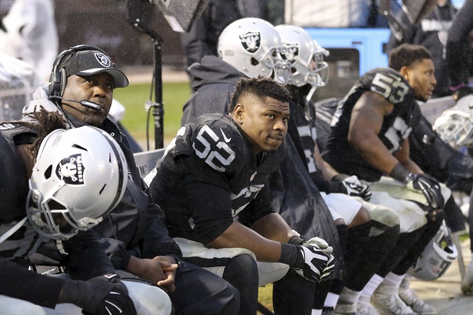 Raiders coaches and players including defensive end Khalil Mack, watch the closing minutes of a 30-20 loss to the Packers. The loss eliminated them from playoff contention