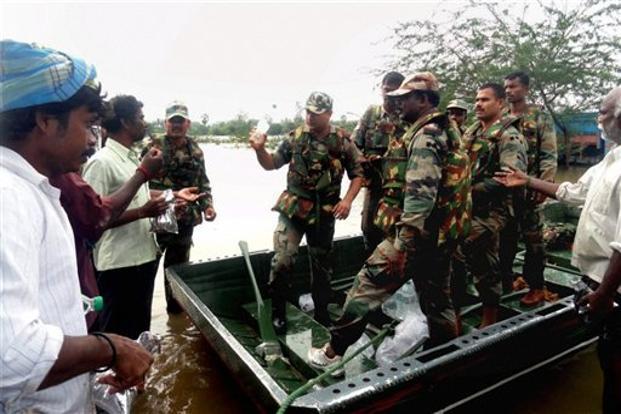 Army personnel distribute food packets to flood affected people in Chennai on Friday