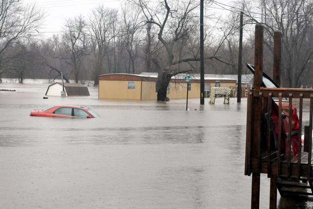 Spring river floods homes in Kendricktown on Sunday. Missouri’s governor has declared a state of emergency because of widespread flooding that has led to multiple fatalities