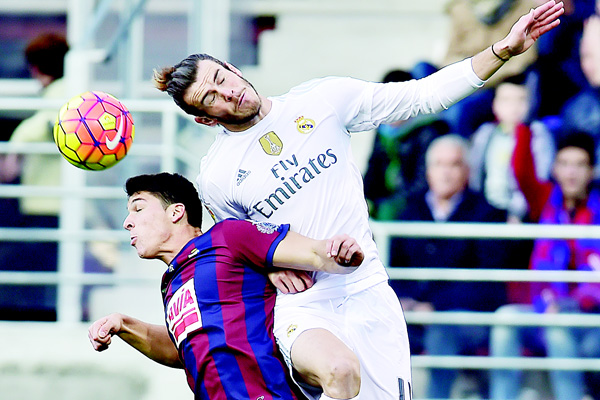 Real Madrid’s Gareth Bale, jumps for the ball with SD Eibar’s Ander Capa during their Spanish La Liga soccer match at Ipurua Stadium in Eibar northern Spain on Nov 29