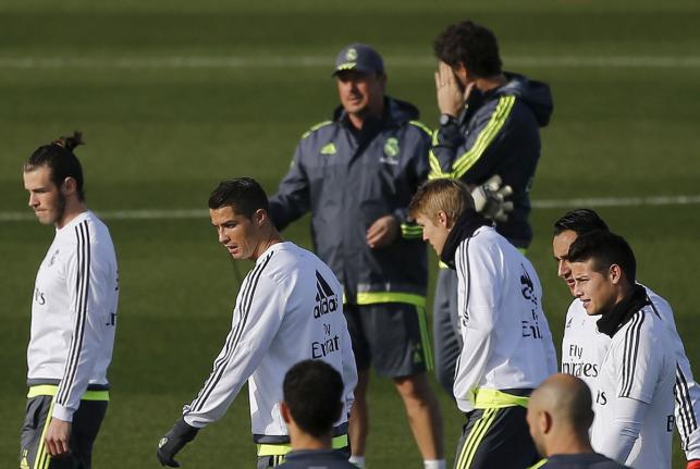 Real Madrid players walk past coach Rafael Benitez during a training session in Valdebebas outside Madrid Spain