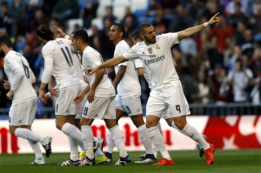 First goal Real Madrid's Karim Benzema right celebrates with teammates after scoring the opening goal against Getafe during the Spanish La Liga soccer match between Real Madrid and Getafe at the Santiago Bernabeu stadium in Madrid Saturday. (AP  Franci