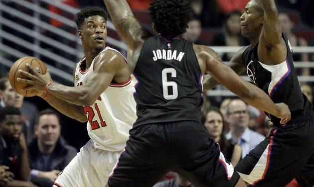 Chicago Bulls guard Jimmy Butler left looks to pass as Los Angeles Clippers guard Jamal Crawford right and center De Andre Jordan guard during the first half of an NBA basketball game on Thursday Dec. 10 2015 in Chicago