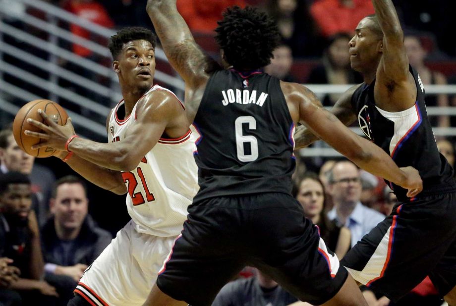 Chicago Bulls guard Jimmy Butler left looks to pass as Los Angeles Clippers guard Jamal Crawford right and center De Andre Jordan guard during the first half of an NBA basketball game on Thursday Dec. 10 2015 in Chicago